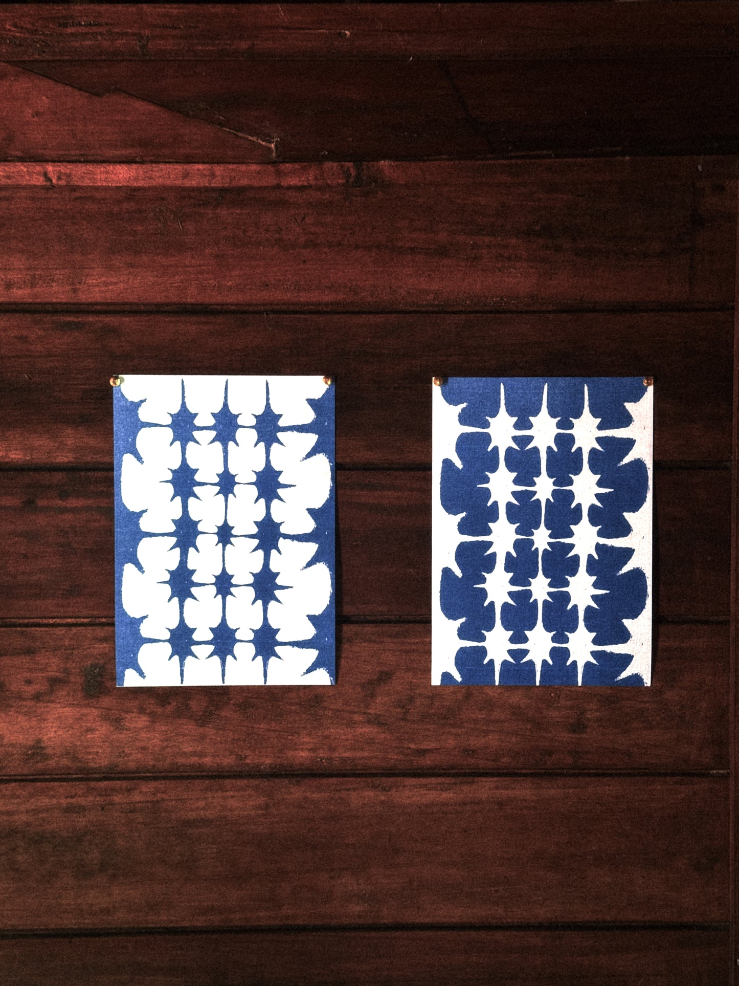 Two blue and white patterned posters on a wooden surface, ritual art to be printed as wall art from The Ancient Now.